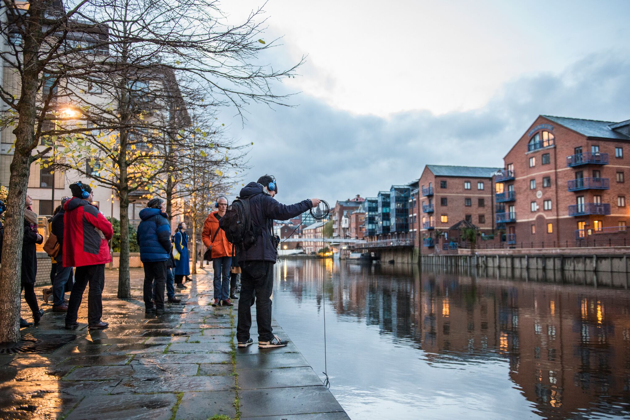 ambulation dipping a hydrophone in the river in Leeds